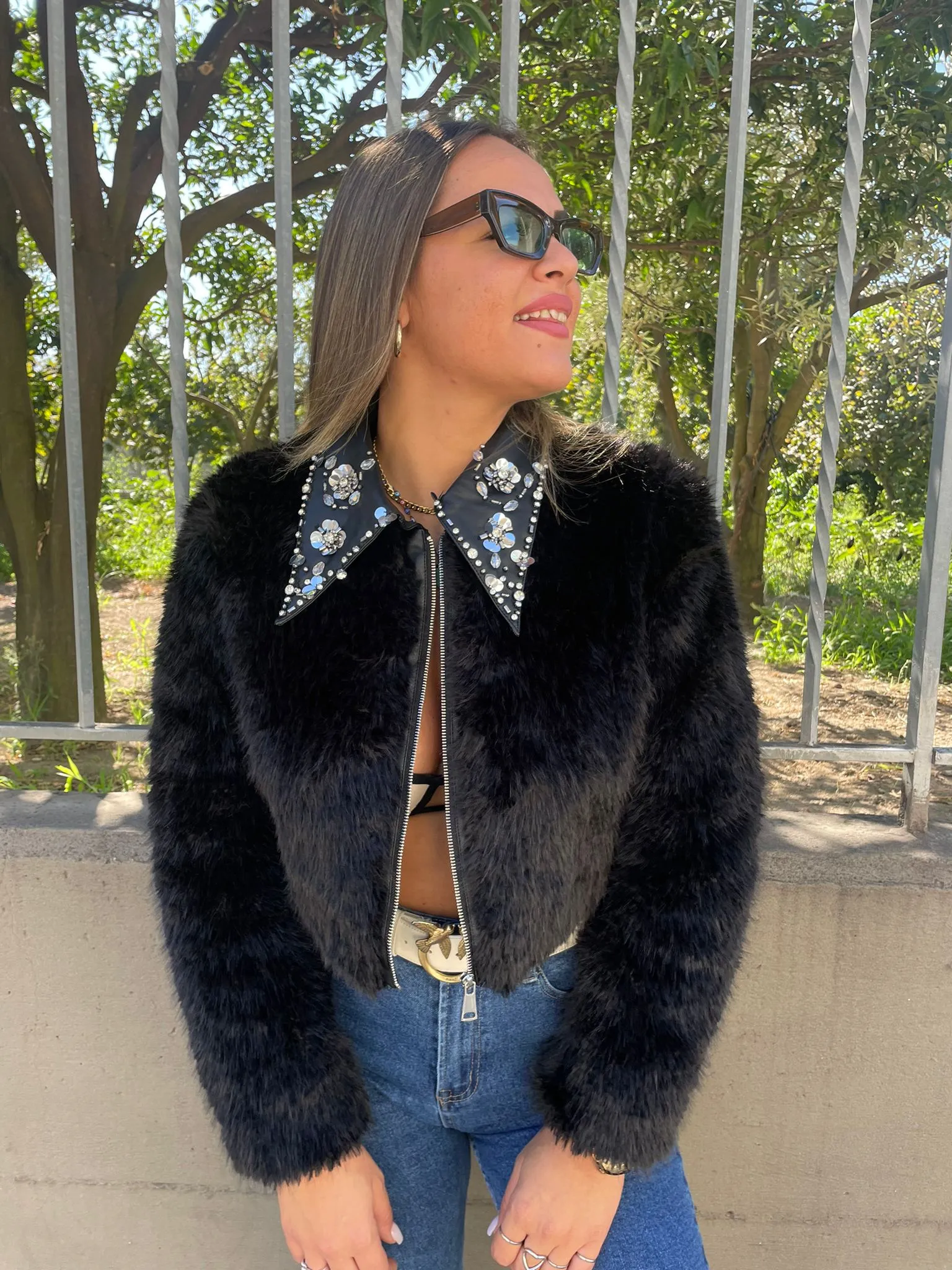 Black faux fur jacket with zip and Swarovski on the collar.