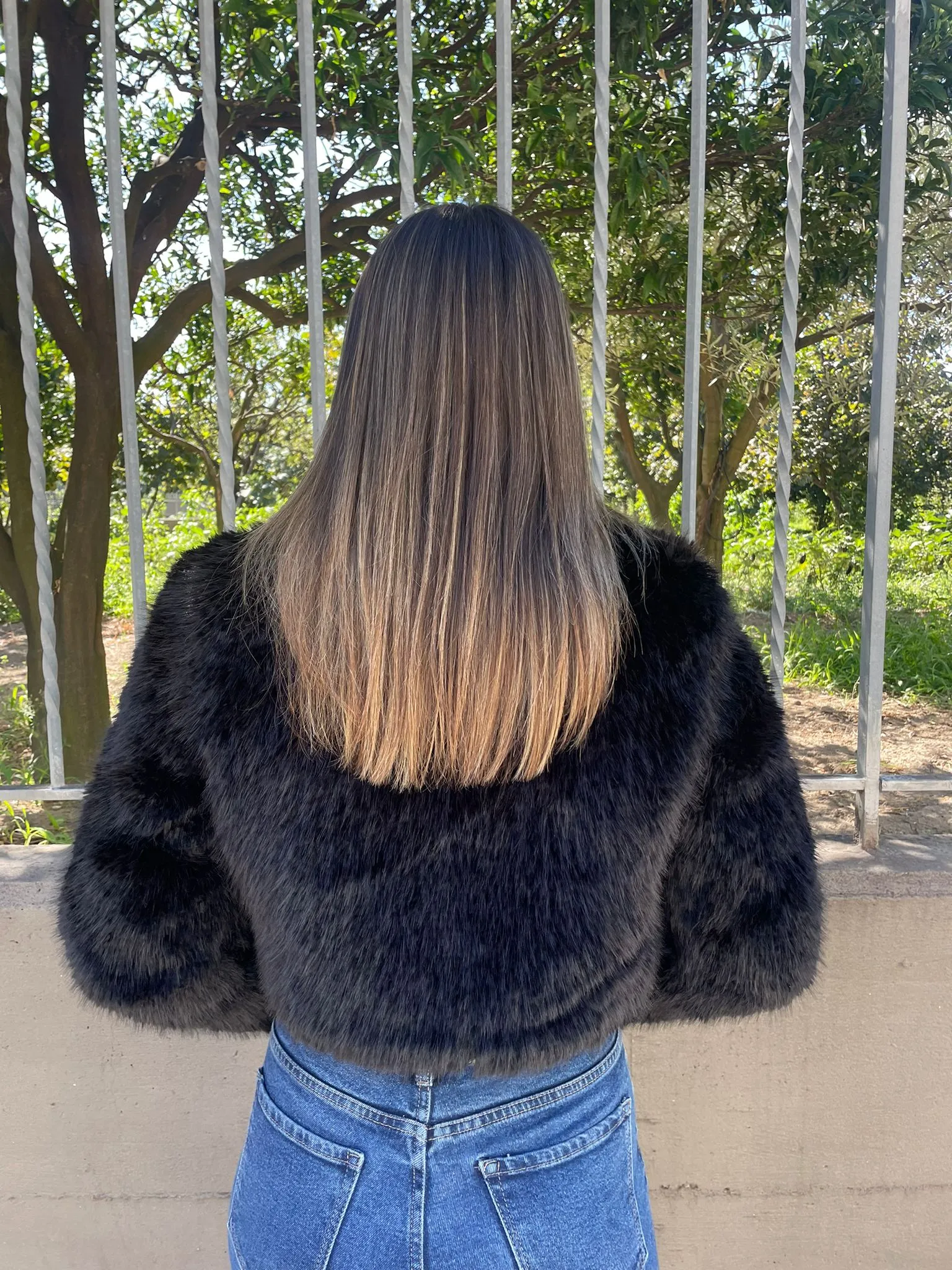 Black faux fur jacket with zip and Swarovski on the collar.