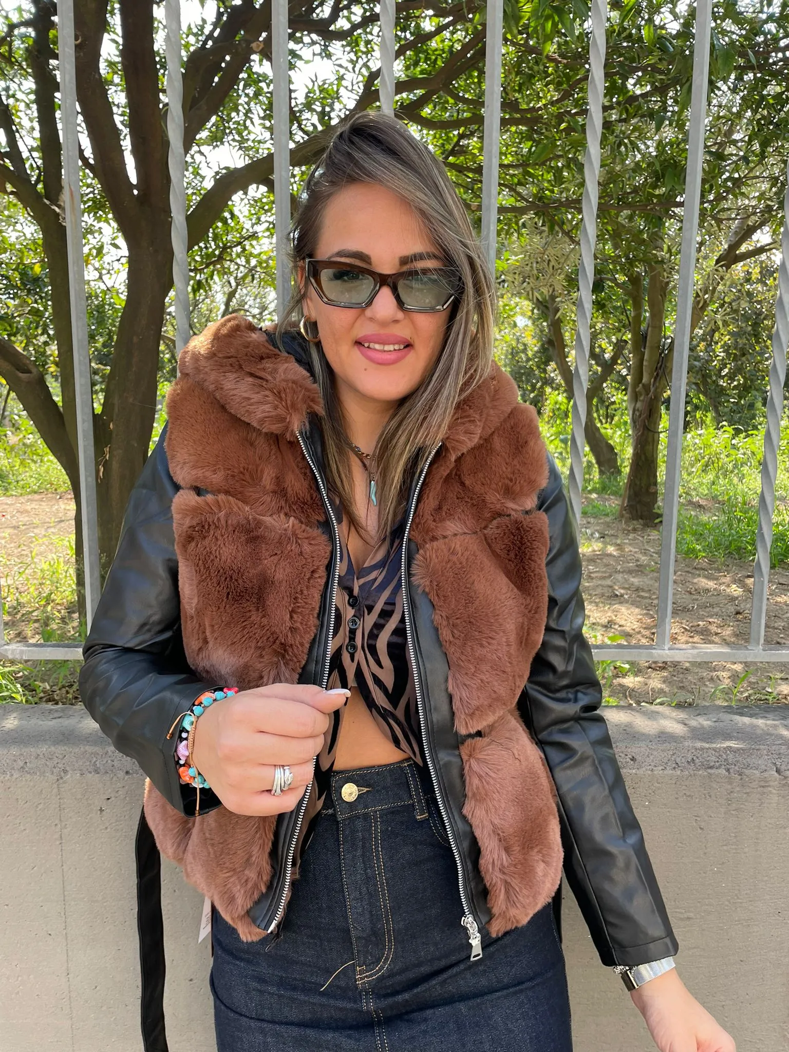 Brown Fur coat with faux leather sleeves.