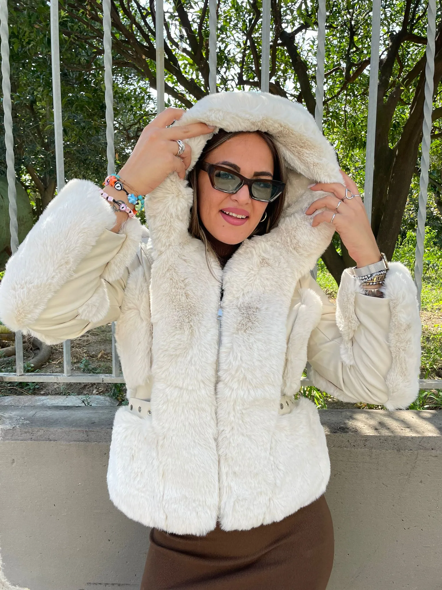 Eco fur jacket with eco leather inserts and hood.