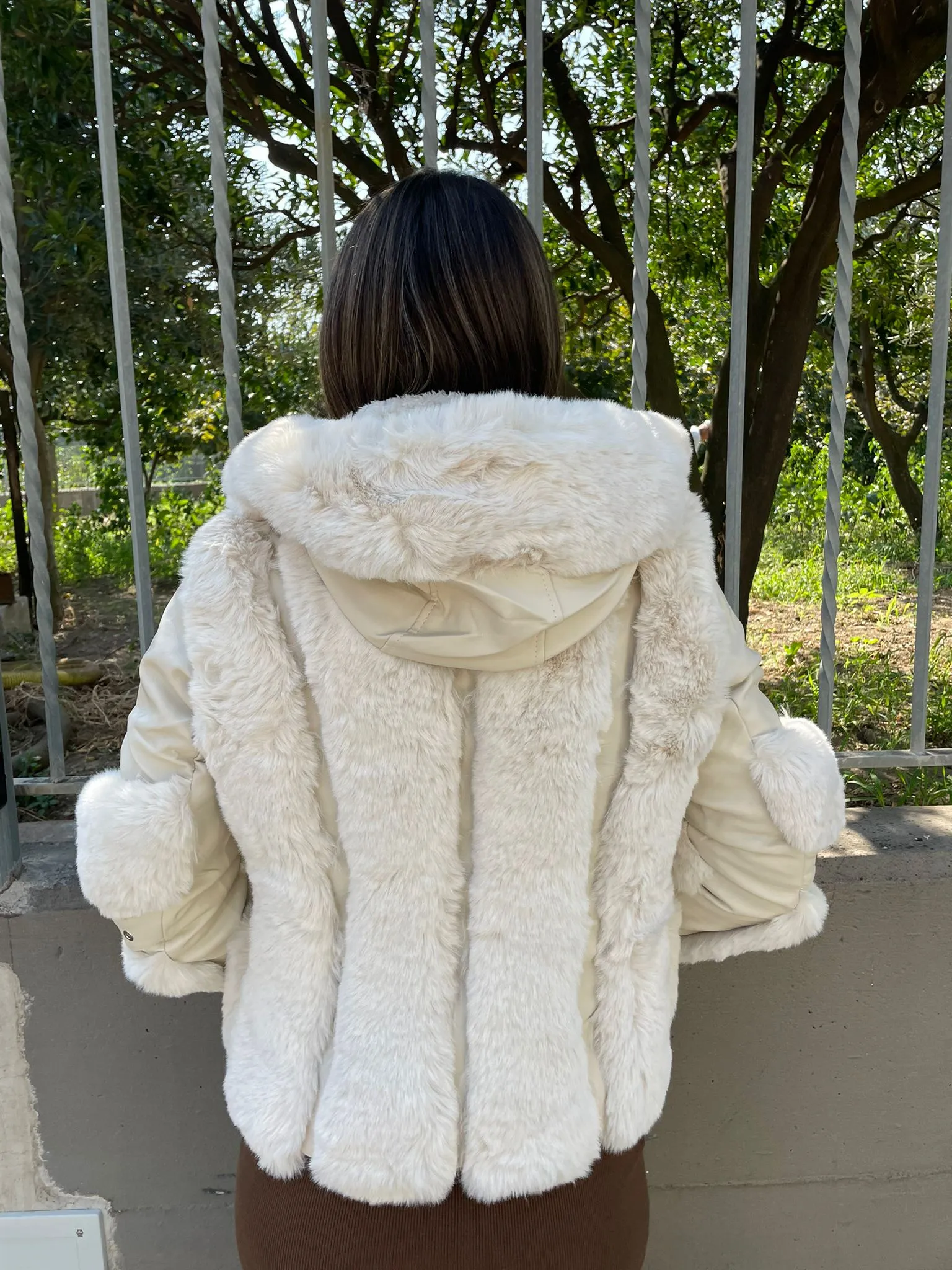 Eco fur jacket with eco leather inserts and hood.