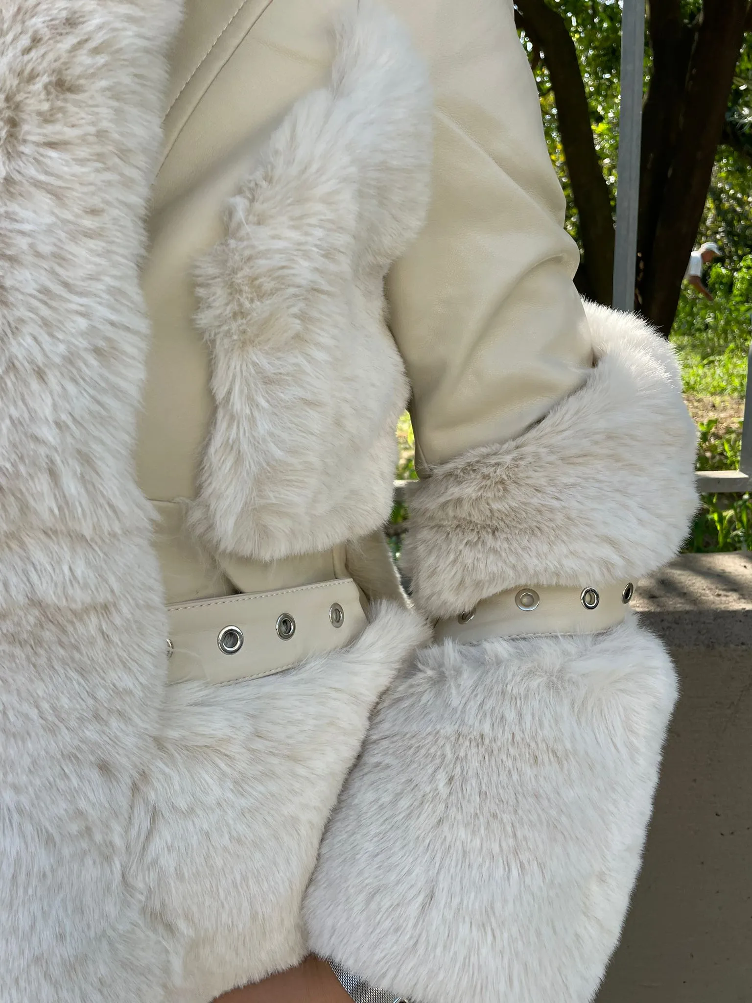 Eco fur jacket with eco leather inserts and hood.