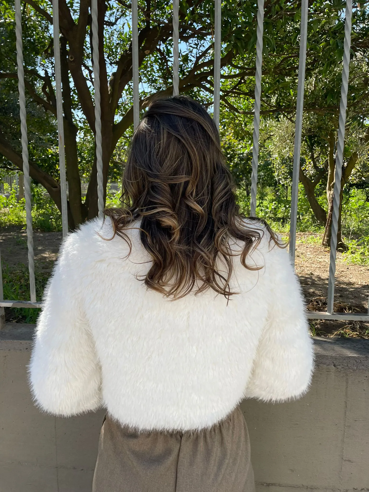 Faux fur jacket with Swarovski zip at the collar.
