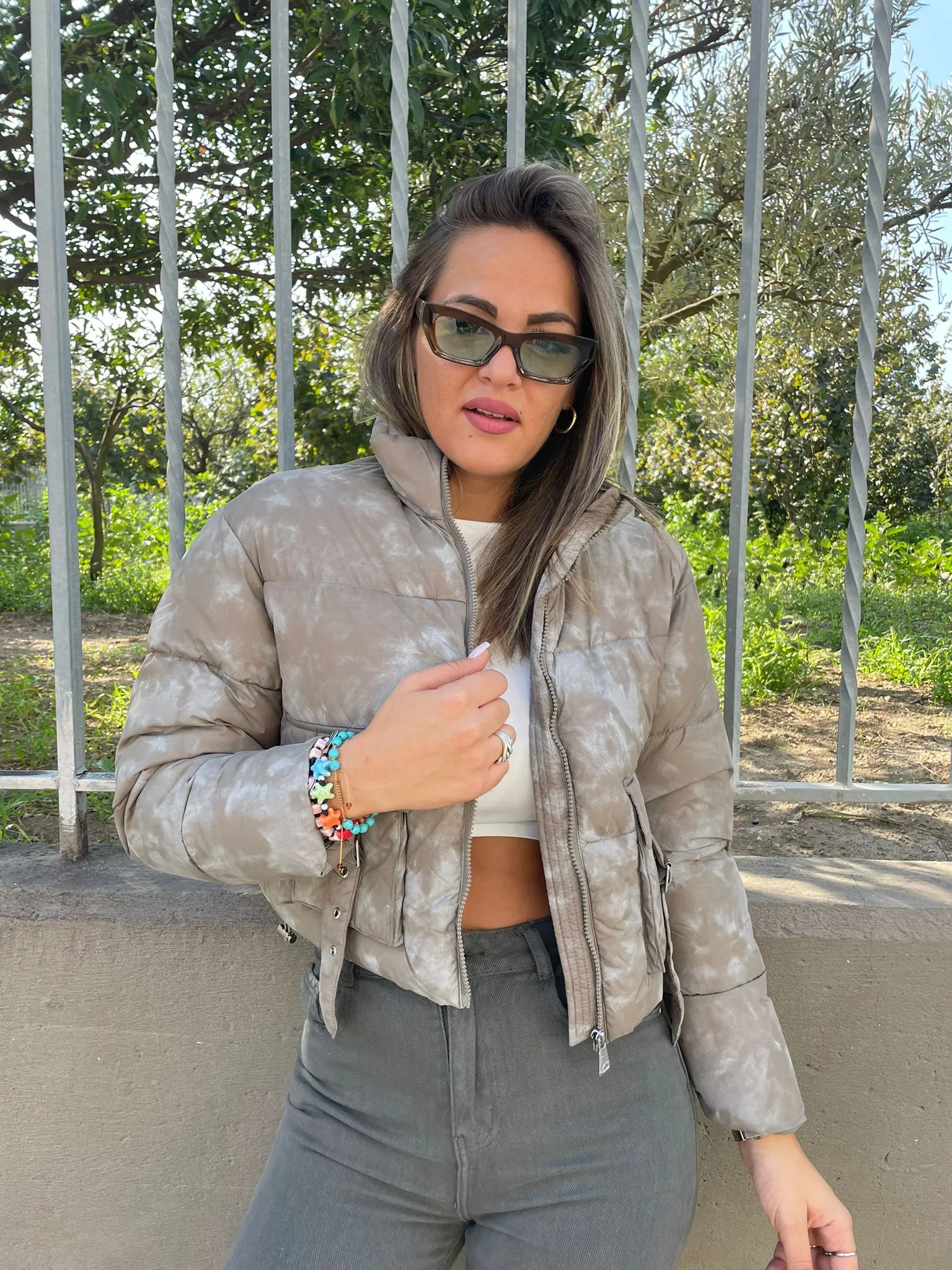 Short green faded bomber jacket with pockets.