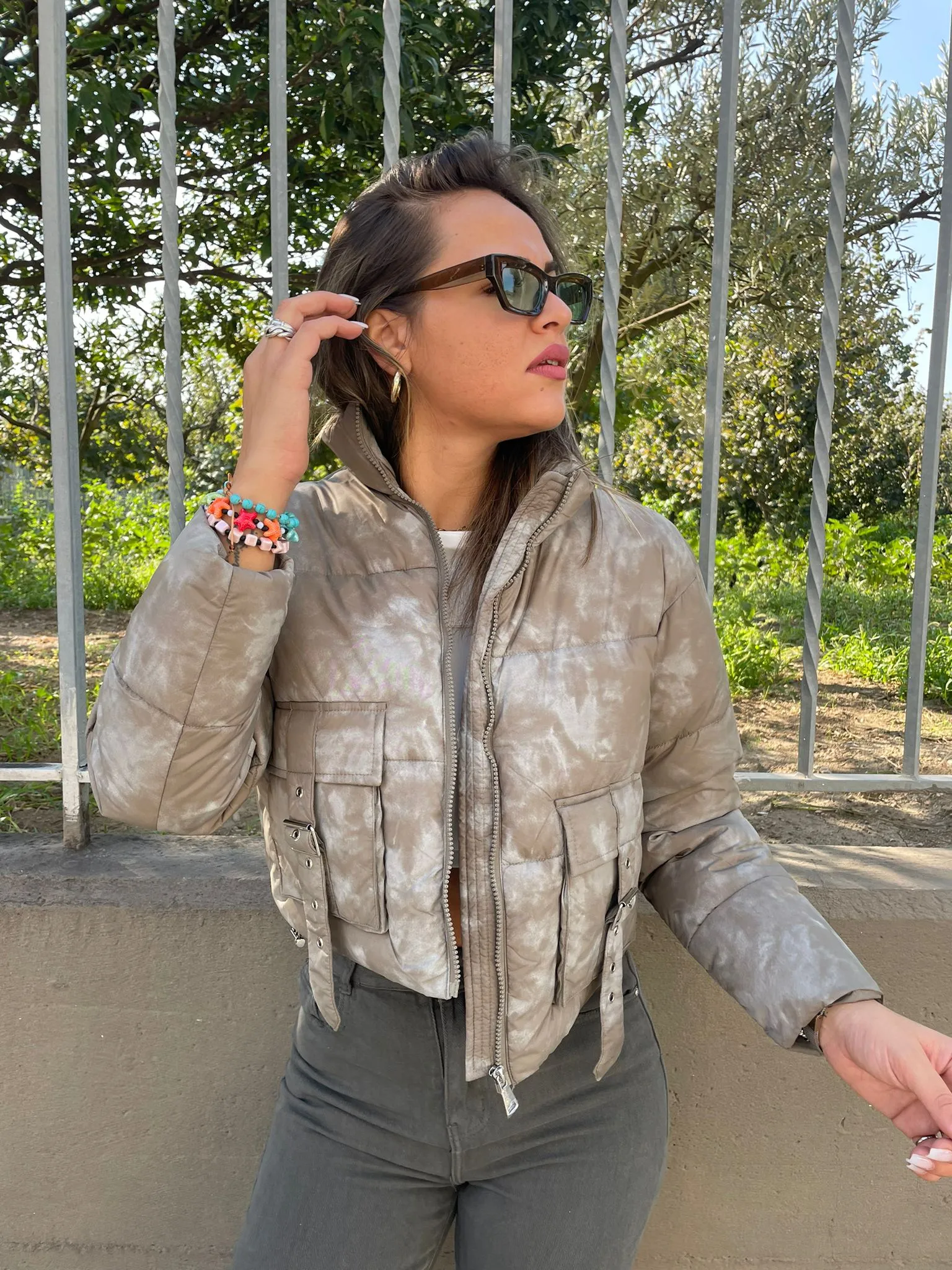 Short green faded bomber jacket with pockets.
