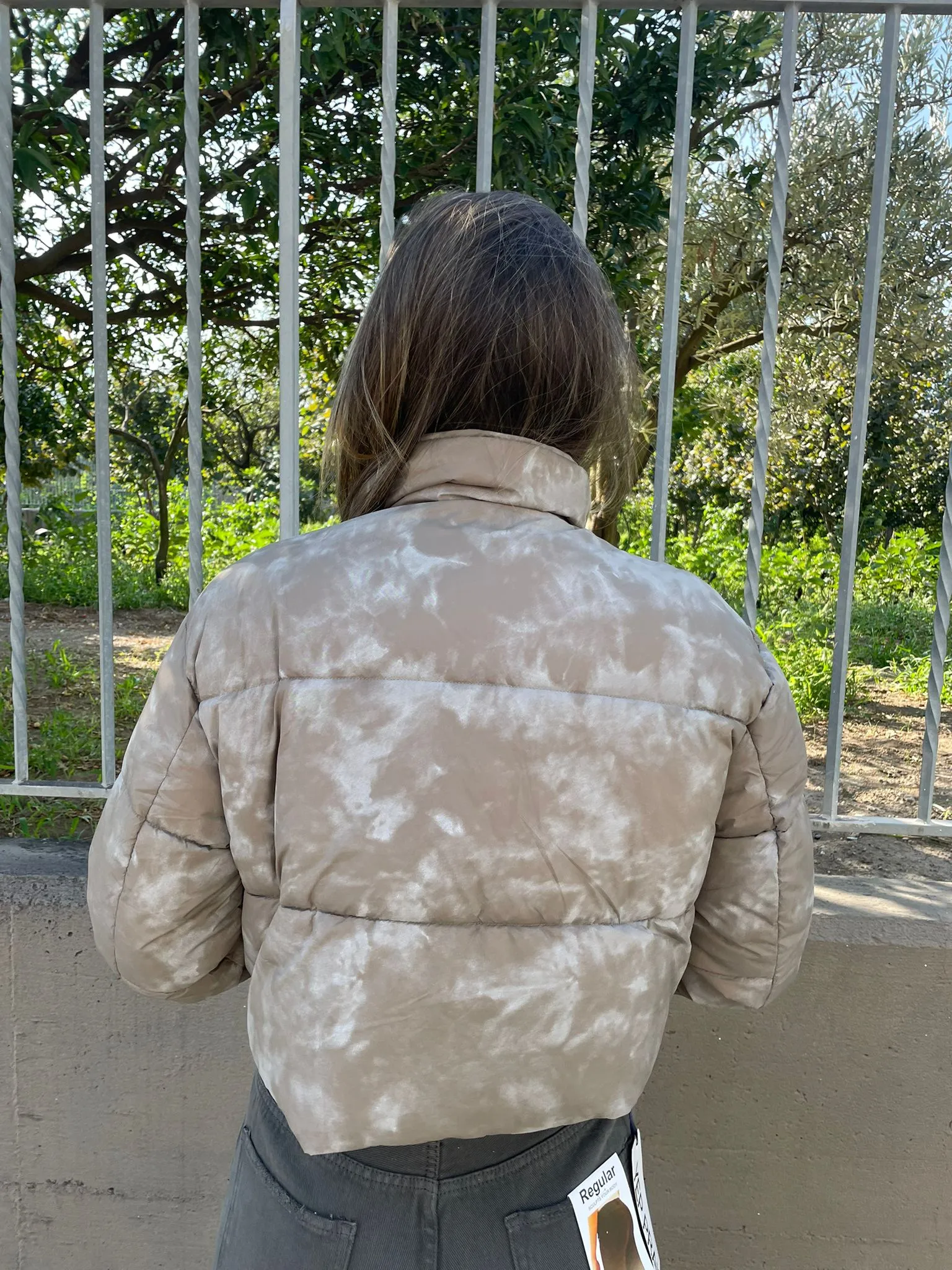 Short green faded bomber jacket with pockets.