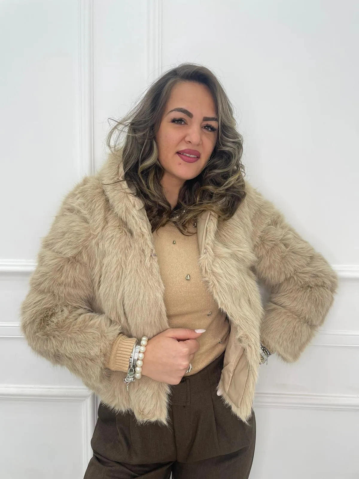 Solid color eco fur coat with patches and hood.