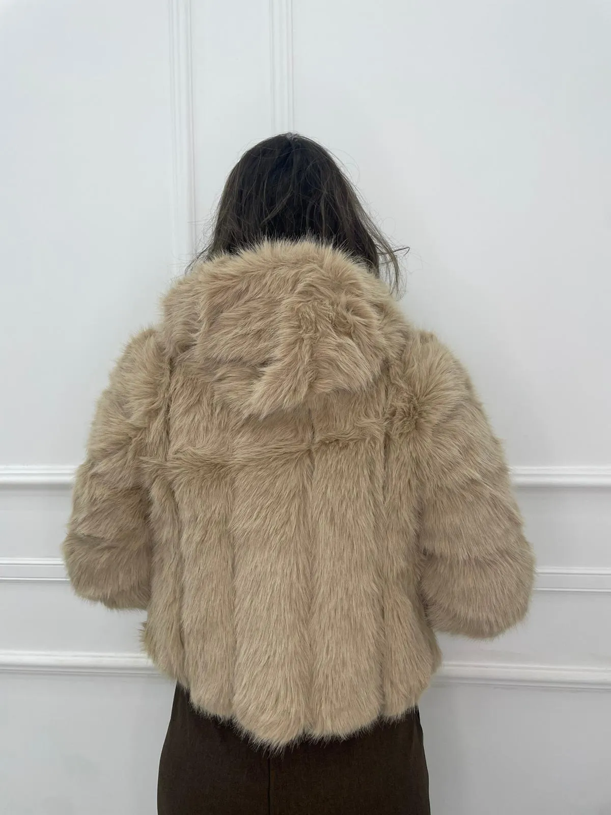Solid color eco fur coat with patches and hood.