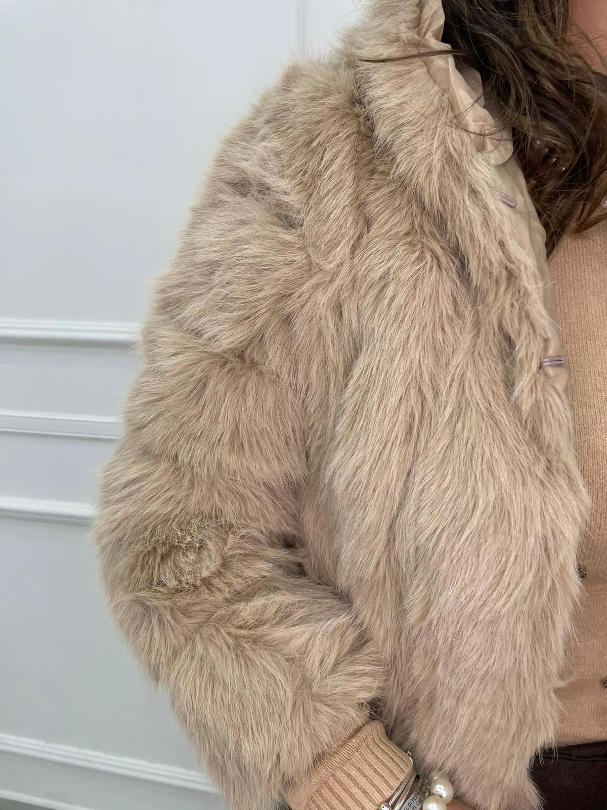Solid color eco fur coat with patches and hood.