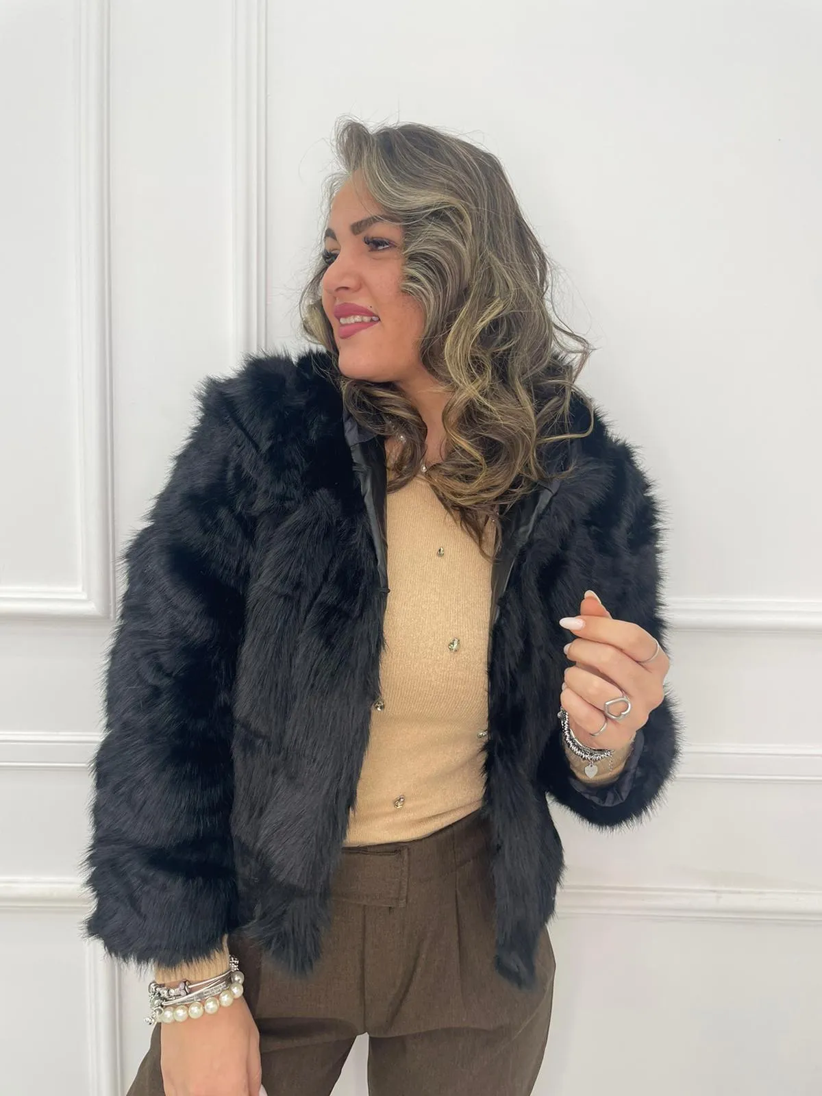 Solid color eco fur coat with patches and hood.