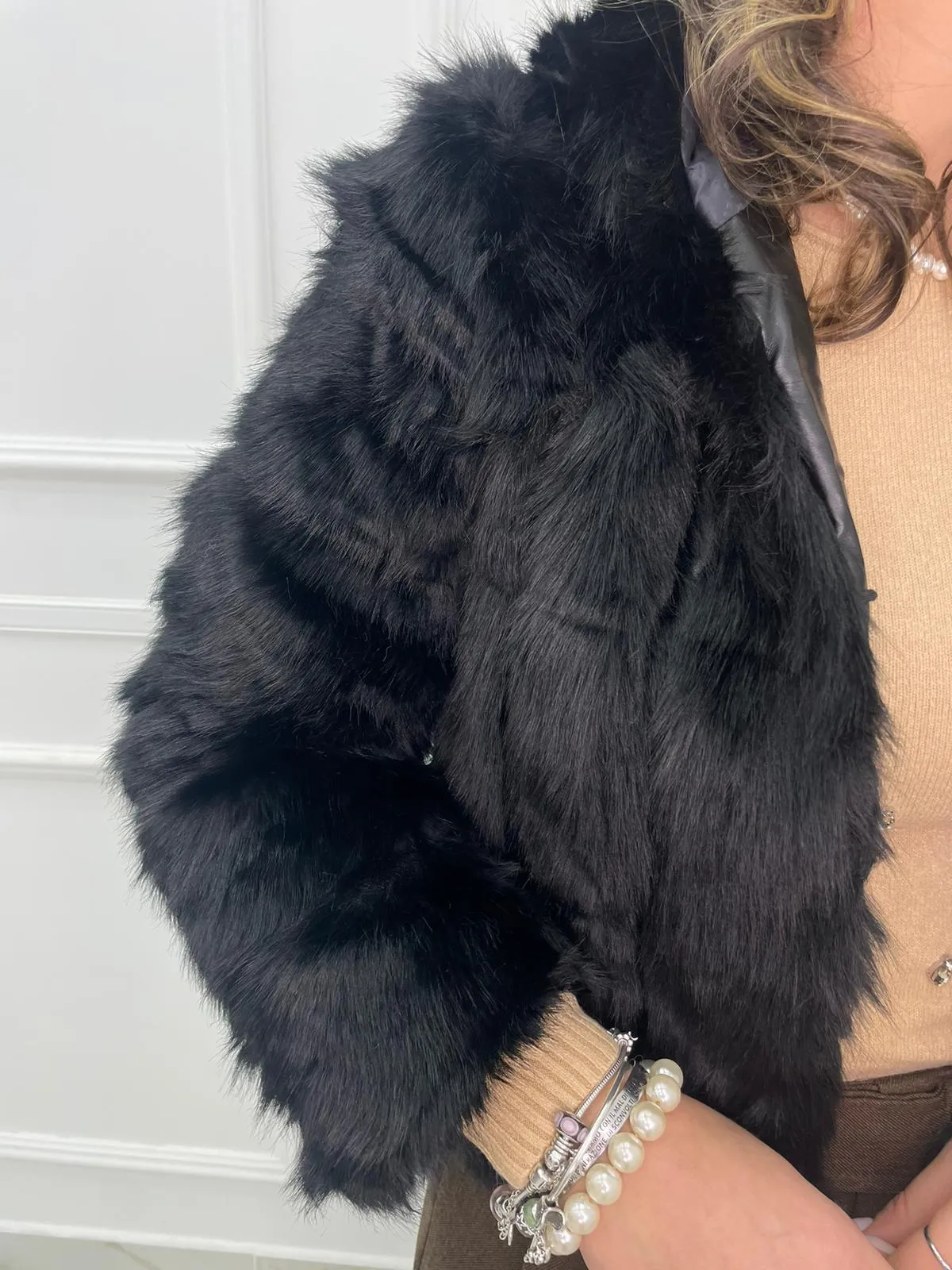 Solid color eco fur coat with patches and hood.