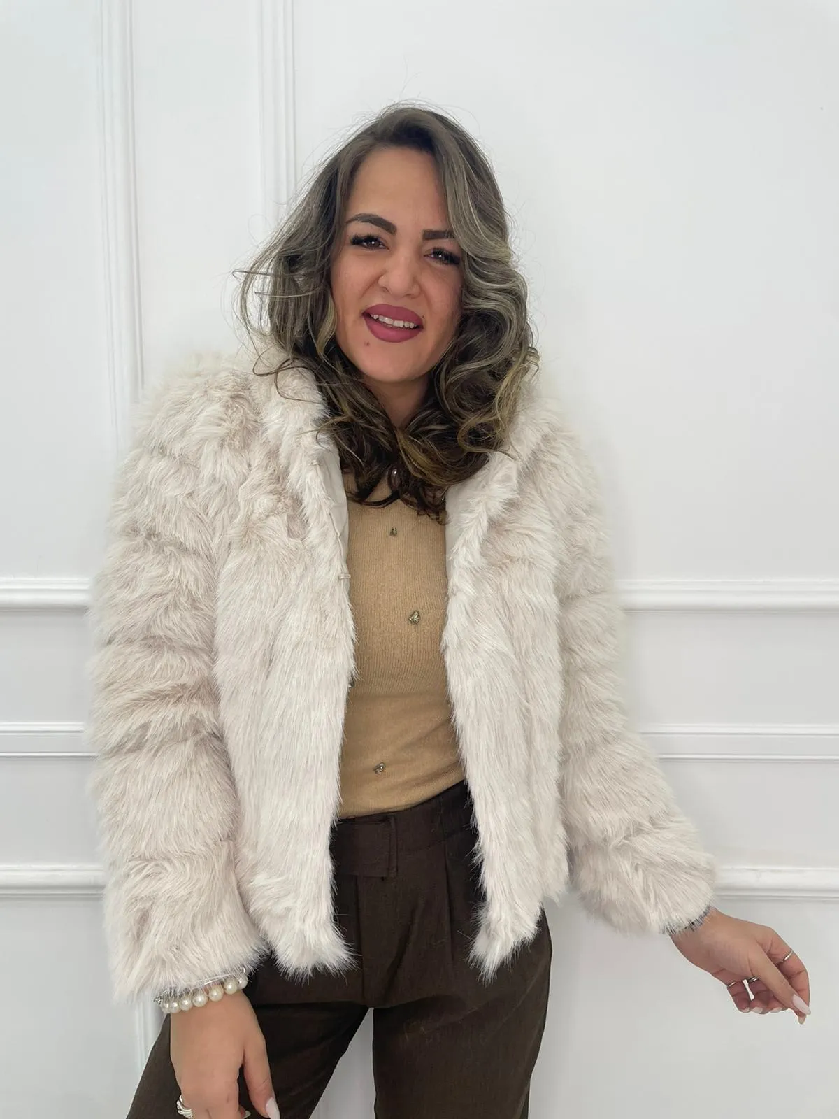 Solid color eco fur coat with patches and hood.