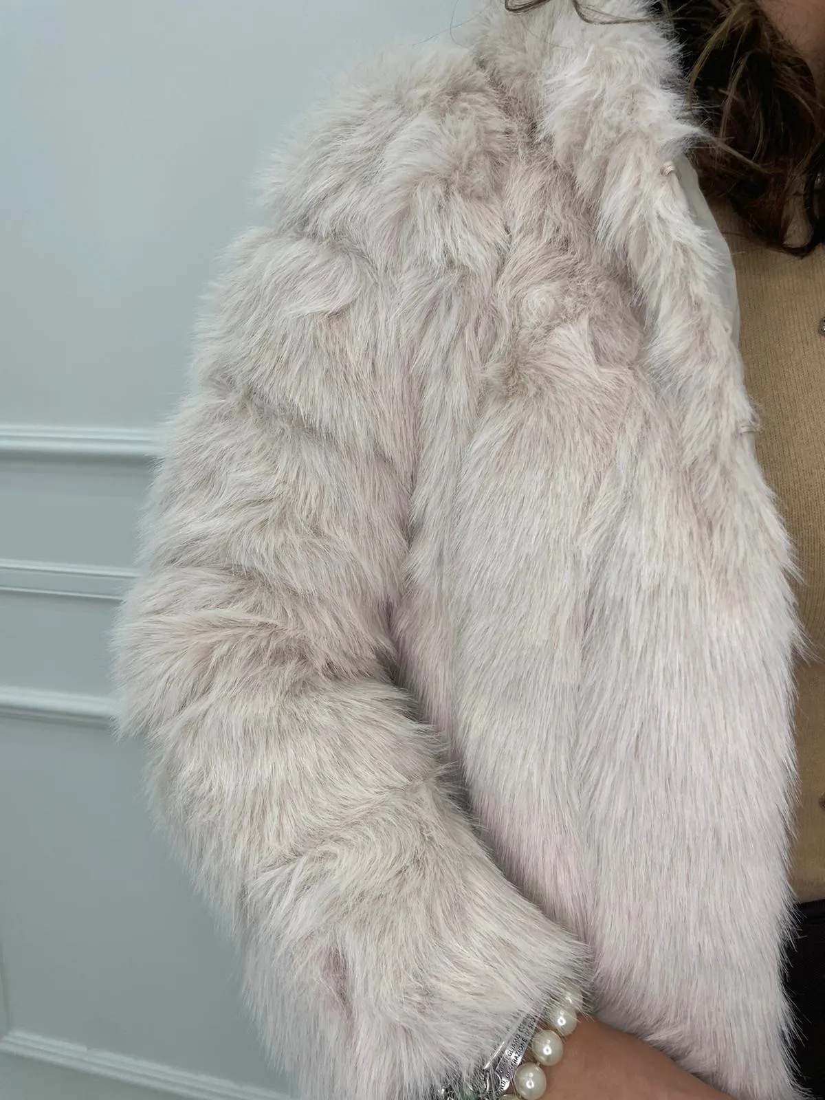 Solid color eco fur coat with patches and hood.